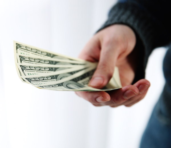 Closeup portrait of a male hand giving money